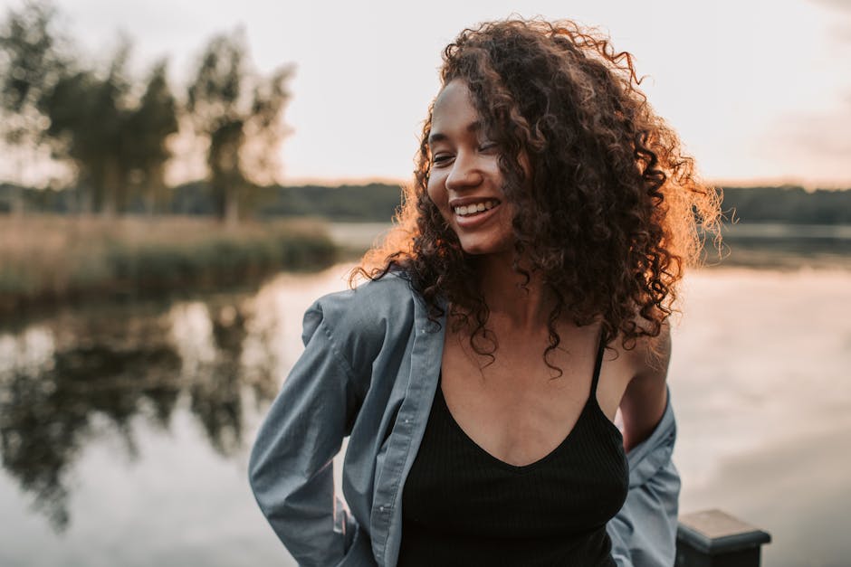Woman in a tranquil warrior pose by a serene lake